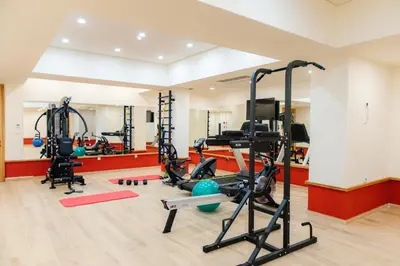 a gym with several treadmills and exercise equipment at Relax Hotel in Palaiochóra