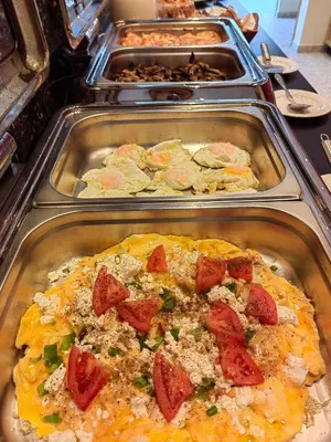 a buffet of food in trays in a cafeteria at Relax Hotel in Palaiochóra