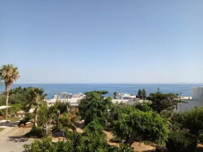 a view of a beach with trees and the ocean at Villa Anastasia in Kalamaki Chanion