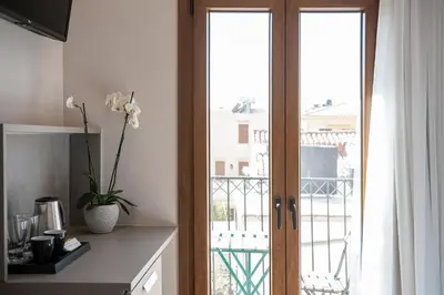 a kitchen with a sliding glass door to a balcony at Al Daliani Minaret Rooms in Chania Town