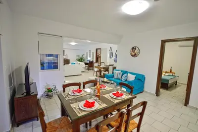 a living room with a table and chairs and a couch at *Haritos traditional Apt-5min from Falassarna Bch* in Kissamos