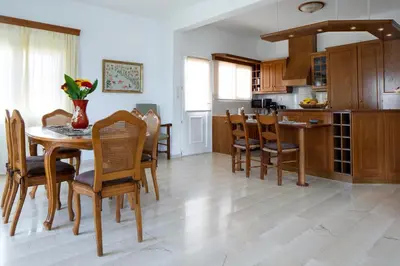 a kitchen and dining room with a table and chairs at Sunset Home with sea view in Chania Town