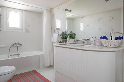 a bathroom with a sink and a tub and a toilet at Sunset Home with sea view in Chania Town