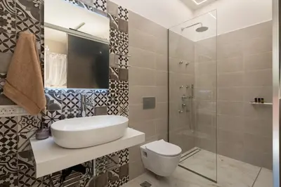 a bathroom with a sink and a shower at Chrisselen Palazzo Colombo in Chania Town