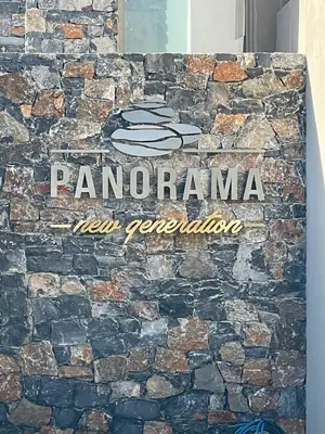 a sign on the side of a stone wall at panorama new generation in Sfakiá