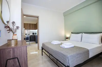 a bedroom with a bed with two towels on it at Gardenia Apartment in Kissamos
