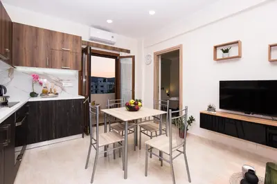 a kitchen and dining room with a table and chairs at Gardenia Apartment in Kissamos