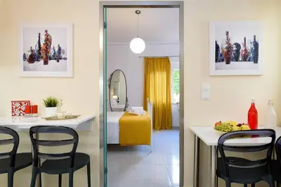 a dining room with a table and chairs in a room at Family home w. yard in Beating Heart of Old Town in Chania Town
