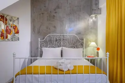 a bedroom with a bed with towels on it at Family home w. yard in Beating Heart of Old Town in Chania Town