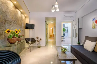 a living room with a couch and a table at Family home w. yard in Beating Heart of Old Town in Chania Town