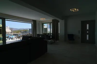 a living room with a couch and a large window at Katakis LuxuryVillas in Chania Town