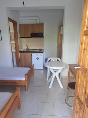 a kitchen with a table and a white table and a table at LITHI in Palaiochóra