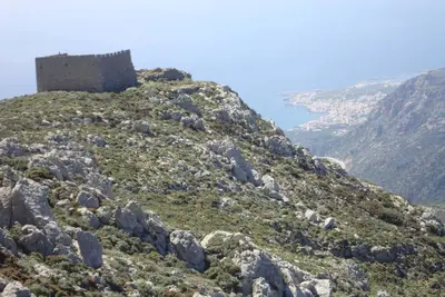 a castle on the side of a mountain at LITHI in Palaiochóra