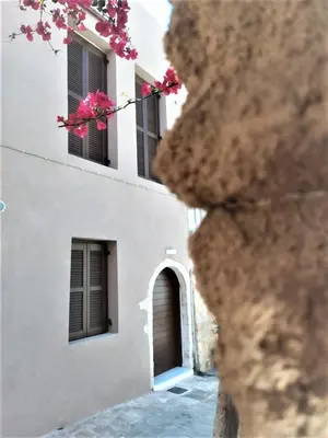 a white building with pink flowers in front of it at Valentina's Luxury House in Chania Town