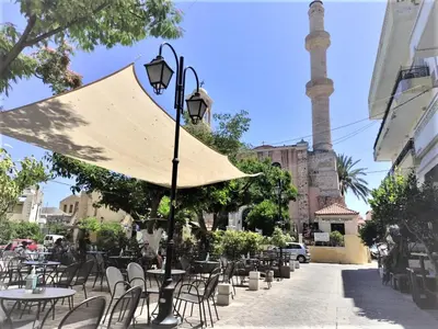 a street with tables and chairs and an umbrella at Valentina's Luxury House in Chania Town