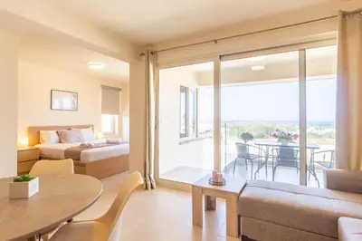 a living room with a couch and a table at Cretan fleur apartments in Elafonisi
