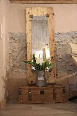 a vase of flowers on top of a wooden chest at Laini Guest Houses in Koulkouthianá