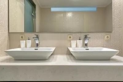 two white sinks in a bathroom with a mirror at Villa Hope in Chania in Mourniaí