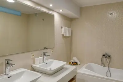 a bathroom with two sinks and a large mirror at Villa Hope in Chania in Mourniaí