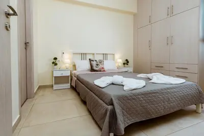 a bedroom with a bed with two towels on it at Chania Oasis with heated pool in Chania Town