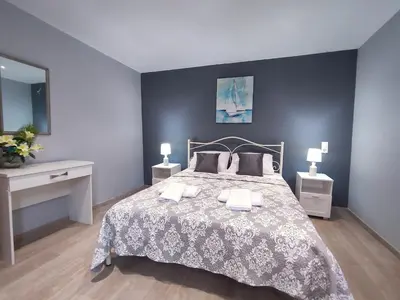 a bedroom with a large bed and two night stands at Rocky Mountain Villa in Ramní