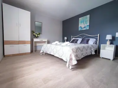 a bedroom with a bed and a blue wall at Rocky Mountain Villa in Ramní