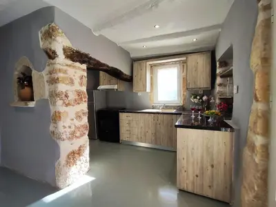 a kitchen with a statue of a woman on the wall at Rocky Mountain Villa in Ramní