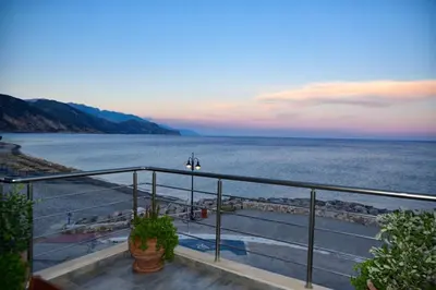a view of the ocean from a balcony at Gonis Grand Luxury Suite in Palaiochóra