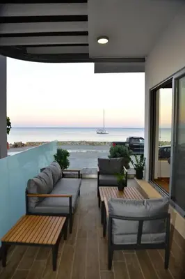 a patio with benches and a view of the ocean at Gonis Grand Luxury Suite in Palaiochóra