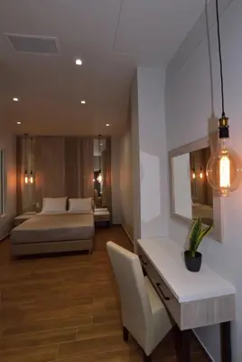 a bedroom with a bed and a desk and a table at Gonis Grand Luxury Suite in Palaiochóra