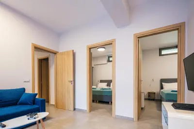 a living room with a blue couch and a bedroom at Centro Golden View Villa in Chania Town