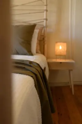 a bedroom with a bed with a lamp on a table at Monastery apartment, a unique house in Chania Town