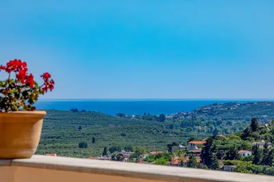 a flower pot sitting on a ledge with a view at Villa Erontas -Private heated jacuzzi and mini pool in Makhairoí