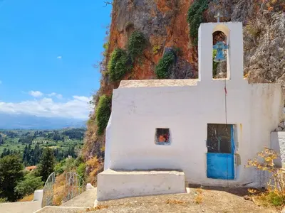 a church on the side of a mountain at Villa Erontas -Private heated jacuzzi and mini pool in Makhairoí