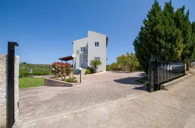 a cobblestone street in front of a white building at Villa Thallo in Galatás