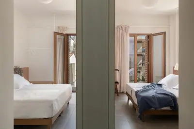 a bedroom with two beds and a window at Lofos Casteli Sunlight in Chania Town