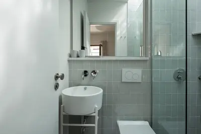 a bathroom with a sink and a toilet and a mirror at Lofos Casteli Sunlight in Chania Town