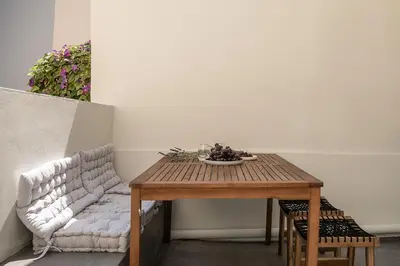 a table with a bowl of fruit and a couch at Lofos Casteli Sunlight in Chania Town