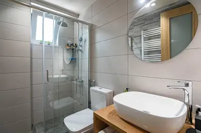 a bathroom with a toilet and a sink and a mirror at Olga's Organic garden Home for a couple! with Wifi & AC in Chania Town