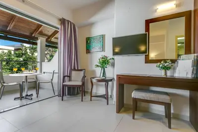 a room with a desk and a table with a mirror at Porto Platanias - Casa Di Porto in Plataniás