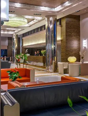a lobby of a hotel with orange furniture at Porto Platanias - Casa Di Porto in Plataniás
