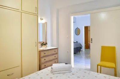 a bedroom with a bed and a dresser and a mirror at Aristea's Apartment 2nd Floor in Chania Town