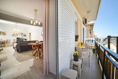 a room with a balcony with a living room at Aristea's Apartment 2nd Floor in Chania Town