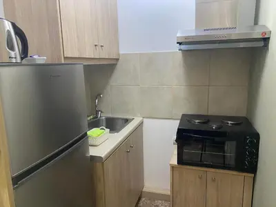 a small kitchen with a sink and a refrigerator at Kissamos Nice Apartment1 in Kissamos
