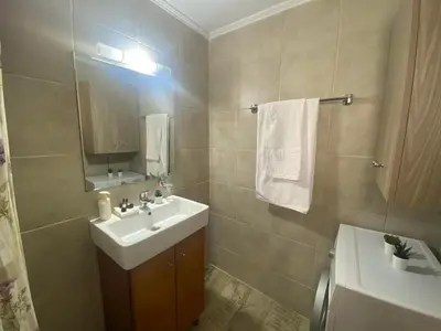a bathroom with a sink and a mirror at Kissamos Nice Apartment1 in Kissamos