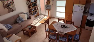an overhead view of a living room and kitchen with a table at Kalyves Mili's house sea view in Plaka