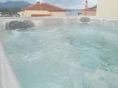 a large pool of water in a hot tub at Kalyves Mili's house sea view in Plaka