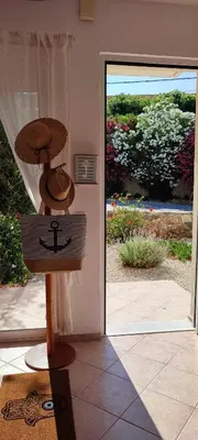 a hat on a stand in front of a door at Kalyves Mili's house sea view in Plaka