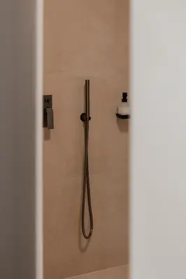 a shower with a hose in a bathroom at Chrissida Hotel in Agia Marina Nea Kydonias