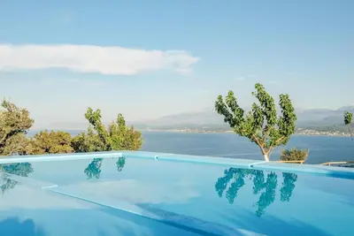 a swimming pool with a view of the water at Villa Akrolithos with Private Pool in Chania Town